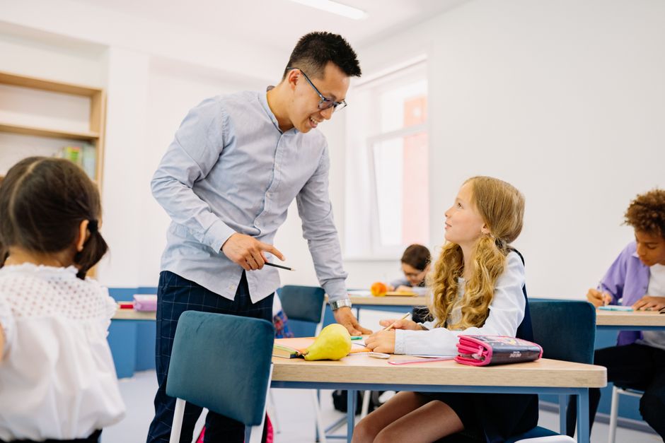 A bright, modern classroom setting with a diverse group of adult students engaged in a lesson, representing the structured environment of in-person real estate classes.