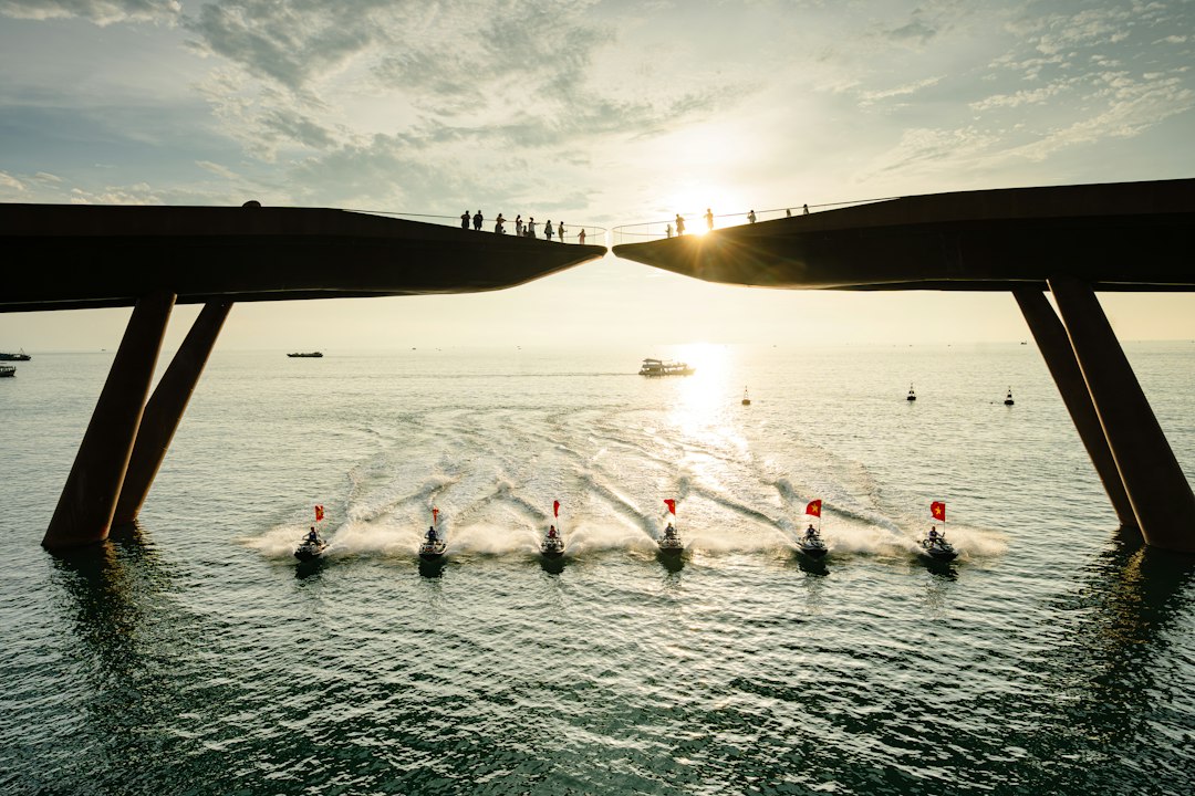 An overhead view of a rowing crew team moving in perfect synchronization on the water, symbolizing teamwork, precision, and shared goals.